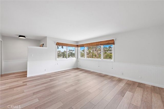 309 W Avenida Valencia, San Clemente, CA 92672 - empty room featuring baseboards, wainscoting, and light wood-style floors