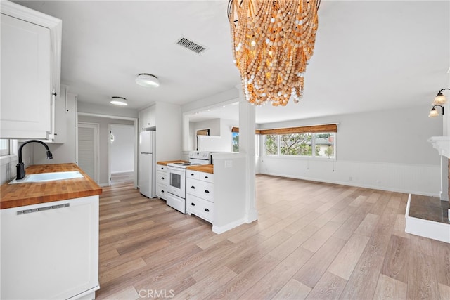 309 W Avenida Valencia, San Clemente, CA 92672 - kitchen featuring a sink, light wood finished floors, white appliances, wood counters, and visible vents