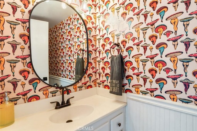 bathroom with vanity and wallpapered walls
