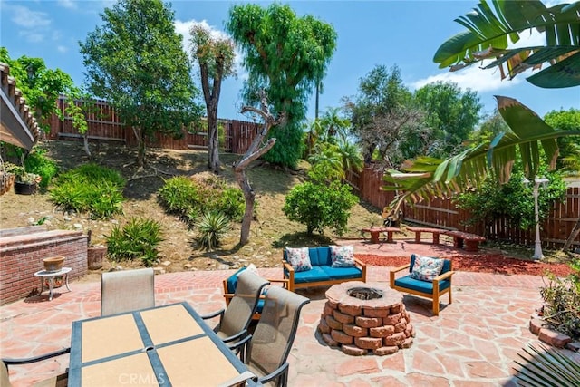 view of patio / terrace with a fenced backyard and an outdoor fire pit