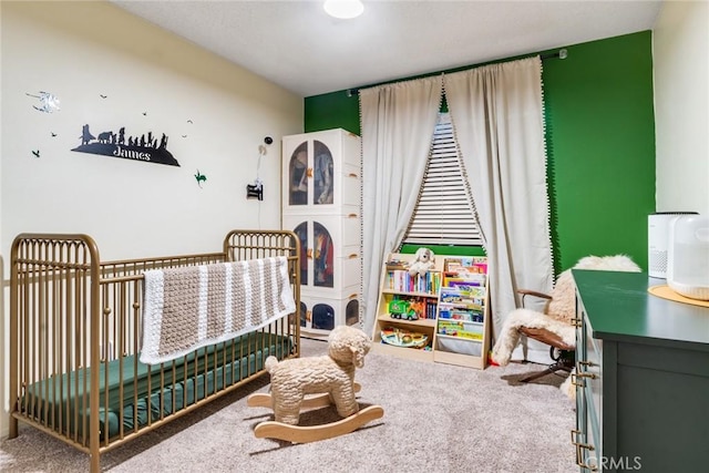 bedroom with carpet and a crib