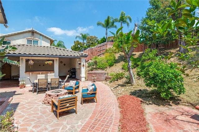 view of patio / terrace featuring an outdoor fire pit, outdoor dining area, a fenced backyard, and a grill
