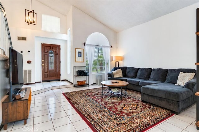 living room with light tile patterned floors, visible vents, and a chandelier