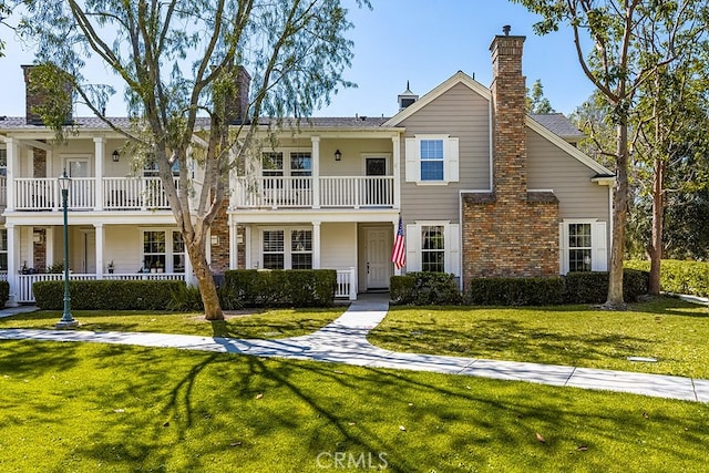 view of front of property with a chimney and a front yard