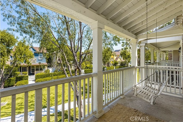 balcony featuring covered porch and a residential view