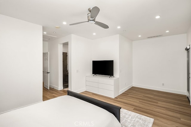 bedroom featuring recessed lighting, visible vents, wood finished floors, and attic access