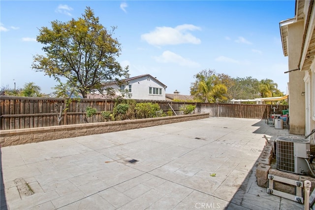 view of patio with a fenced backyard and central air condition unit