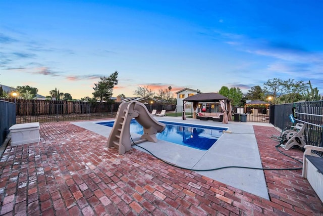 16016 Spangler Peak Rd, Ramona, CA 92065 - pool at dusk featuring a fenced backyard, a fenced in pool, a patio area, a gazebo, and a water slide