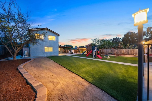 16016 Spangler Peak Rd, Ramona, CA 92065 - yard at dusk featuring a playground, fence, and a patio
