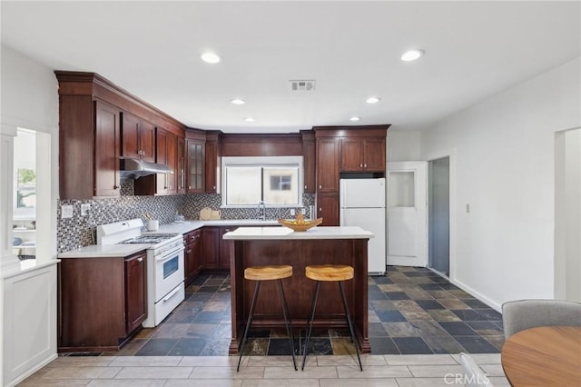 1781 Whitefield Rd, Pasadena, CA 91104 - kitchen with visible vents, white appliances, light countertops, under cabinet range hood, and backsplash