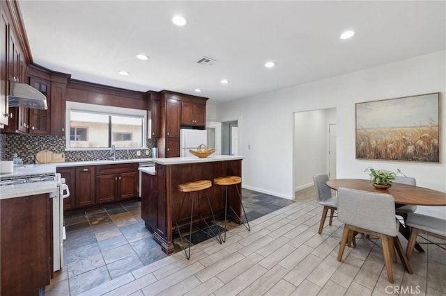 1781 Whitefield Rd, Pasadena, CA 91104 - kitchen featuring visible vents, decorative backsplash, white appliances, light countertops, and under cabinet range hood