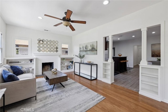 1781 Whitefield Rd, Pasadena, CA 91104 - living area with ceiling fan, recessed lighting, decorative columns, wood finished floors, and visible vents