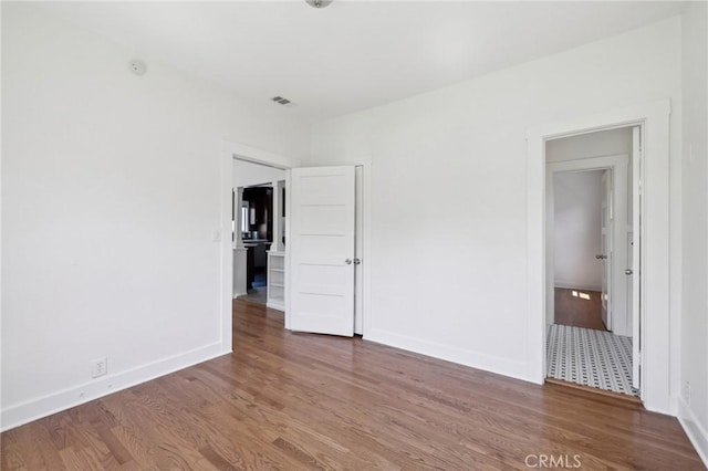 1781 Whitefield Rd, Pasadena, CA 91104 - unfurnished bedroom with baseboards, wood finished floors, and visible vents