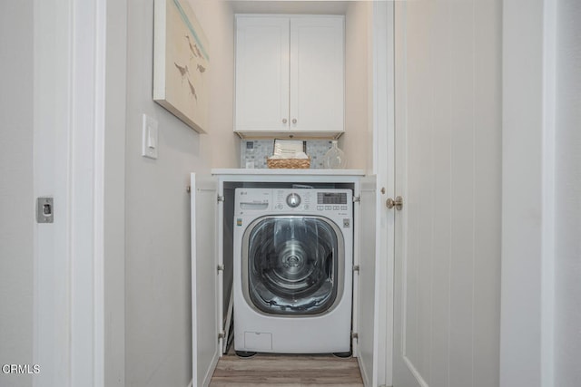 3534 Ocean Dr, Oxnard, CA 93035 - washroom with light wood-style floors, washer / dryer, and cabinet space