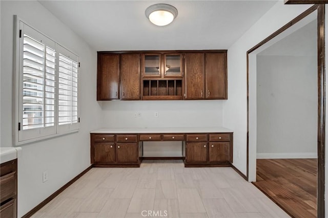 interior space with built in study area and baseboards
