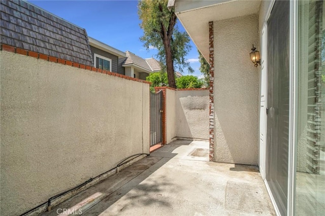 view of patio / terrace featuring fence and a gate