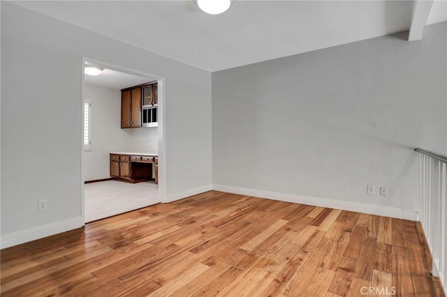 interior space featuring baseboards and light wood-style flooring