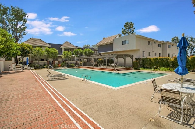 pool featuring a pergola and a patio
