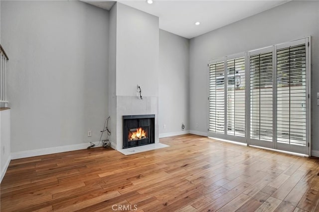 10201 Mason Ave Unit 116, Chatsworth, CA 91311 - unfurnished living room featuring baseboards, a fireplace, recessed lighting, and wood finished floors