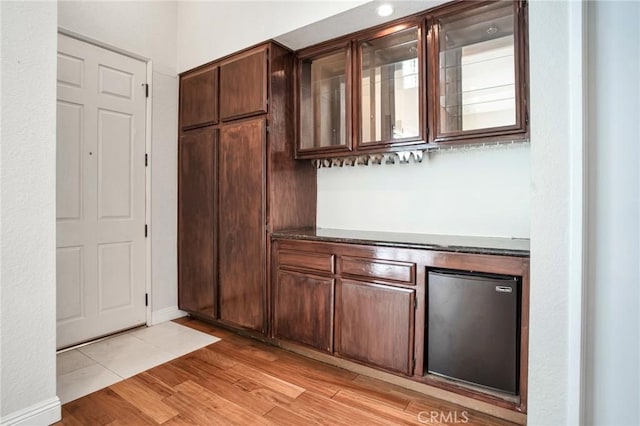 10201 Mason Ave Unit 116, Chatsworth, CA 91311 - bar with light wood-style floors, a bar, and refrigerator