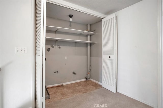 clothes washing area with laundry area, baseboards, and hookup for a gas dryer