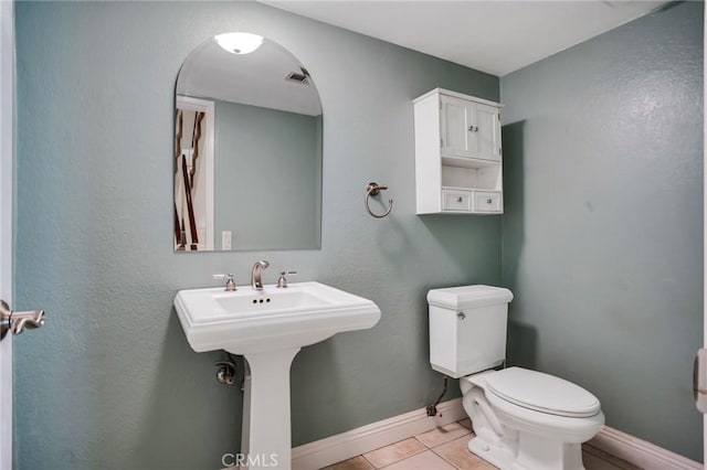 10201 Mason Ave Unit 116, Chatsworth, CA 91311 - bathroom featuring a sink, tile patterned floors, baseboards, and toilet