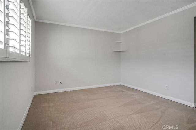 unfurnished room with crown molding, carpet flooring, and baseboards