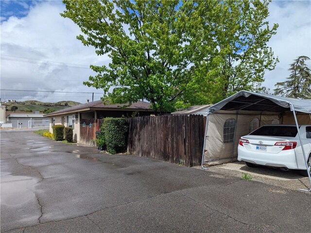 exterior space with fence and a detached carport