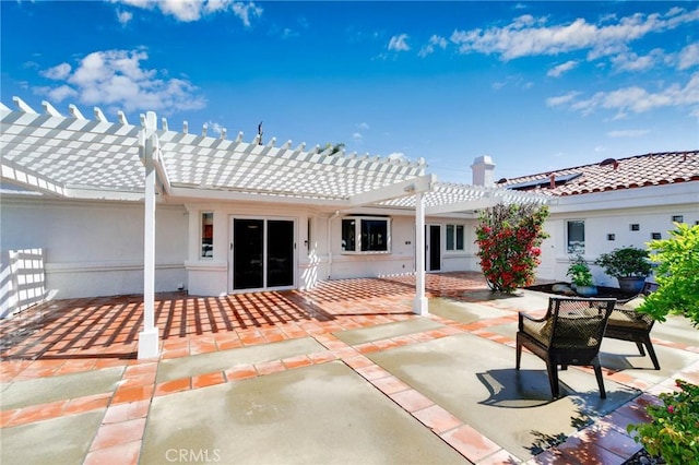 back of property featuring a pergola, a tile roof, and a patio