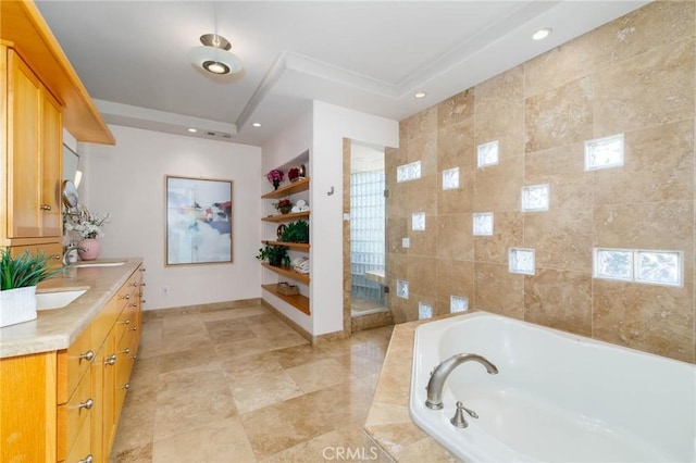 full bathroom with double vanity, built in features, recessed lighting, baseboards, and a garden tub