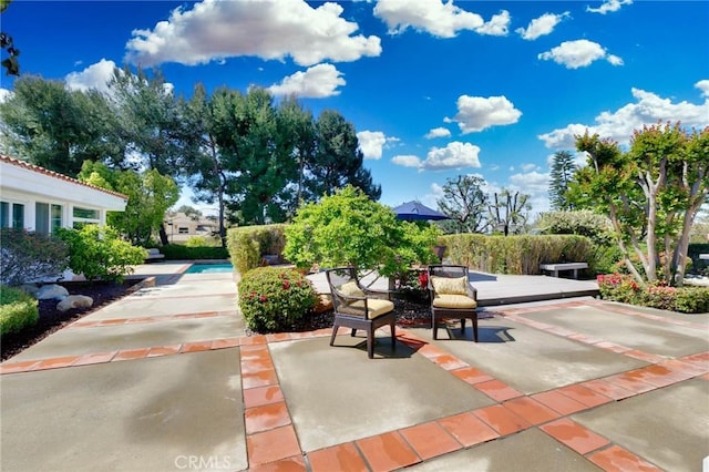 surrounding community featuring a patio area