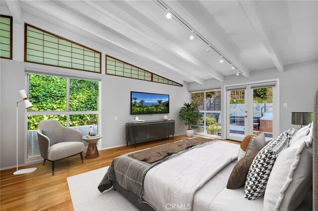 bedroom with access to outside, track lighting, french doors, vaulted ceiling with beams, and wood finished floors
