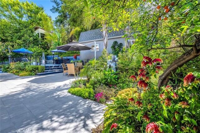 exterior space with a deck, outdoor dining space, and a patio area