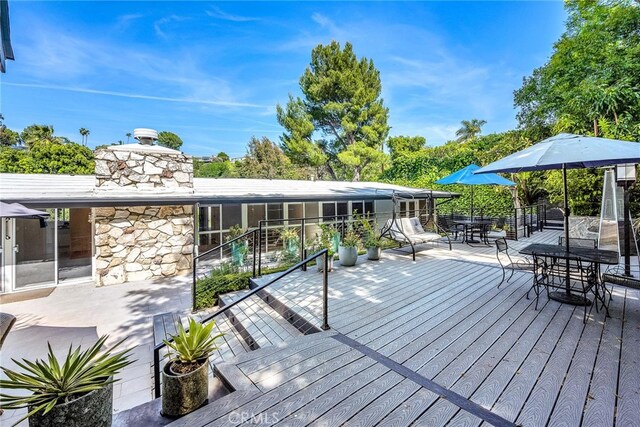 wooden deck featuring outdoor dining space