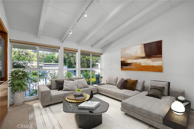 living room featuring vaulted ceiling with beams and rail lighting