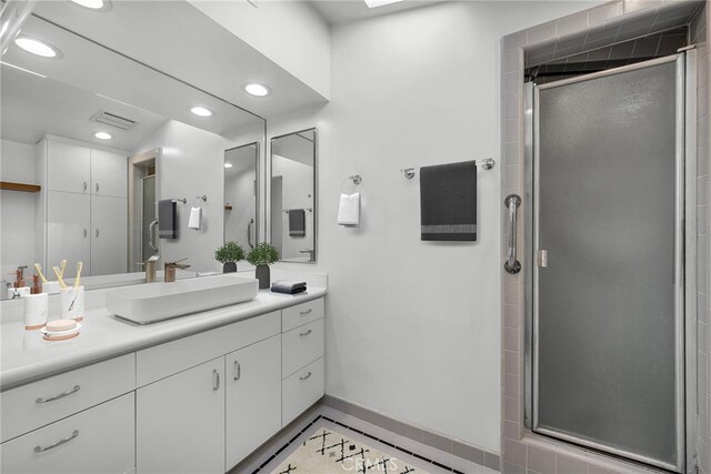 bathroom with visible vents, a stall shower, vanity, baseboards, and recessed lighting