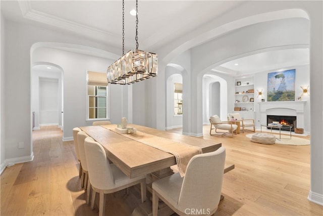 598 N Conejo School Rd, Thousand Oaks, CA 91362 - dining area with arched walkways, built in shelves, light wood-style floors, crown molding, and recessed lighting