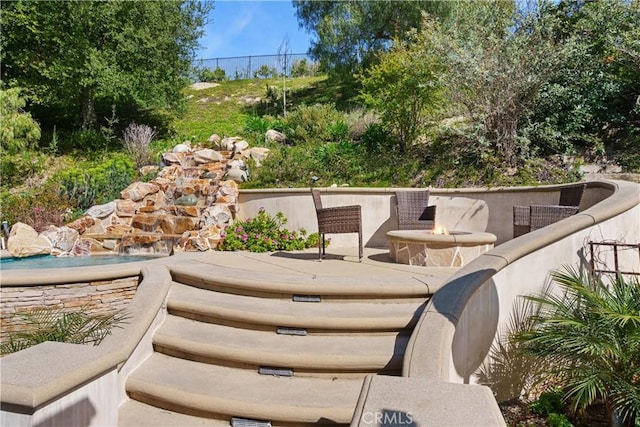 view of patio / terrace featuring a fire pit
