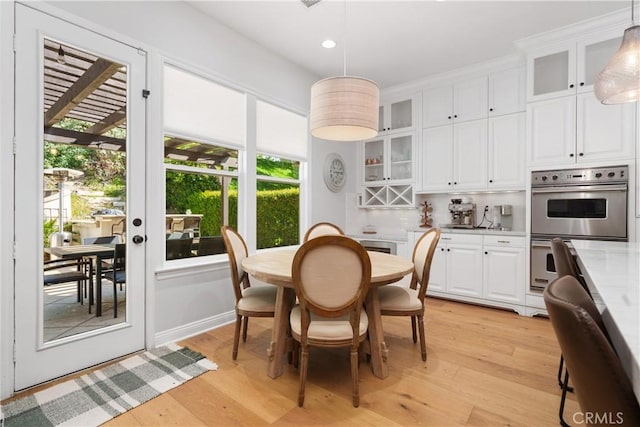 dining area with recessed lighting and light wood-style flooring