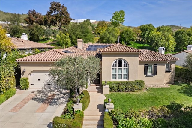 598 N Conejo School Rd, Thousand Oaks, CA 91362 - mediterranean / spanish home with a chimney, a tiled roof, concrete driveway, solar panels, and an attached garage