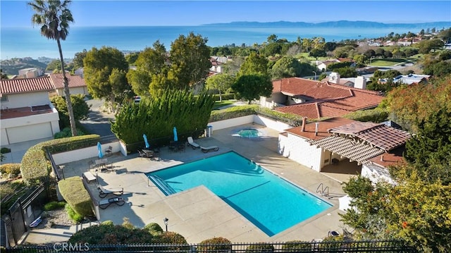 community pool featuring fence and a patio area