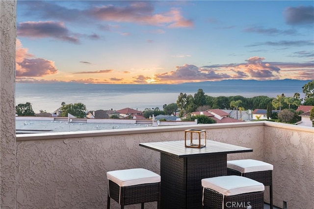 balcony at dusk with a water view