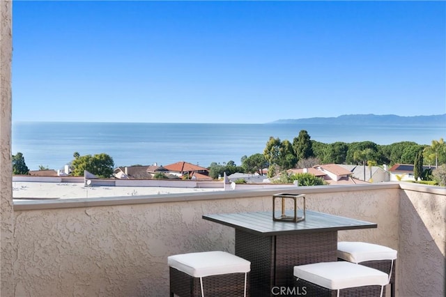 balcony featuring a water view