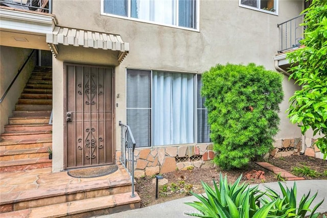 doorway to property with stucco siding