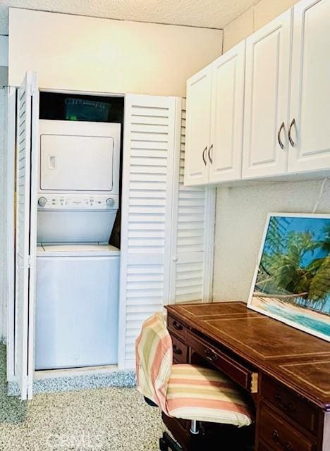 laundry area with laundry area and stacked washer / dryer