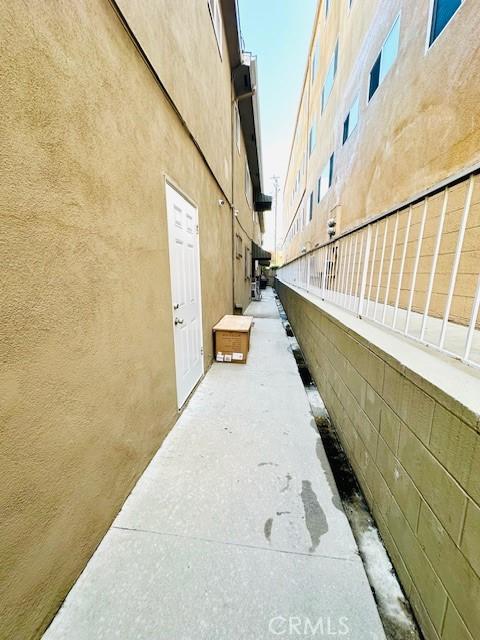 view of side of property with fence and stucco siding