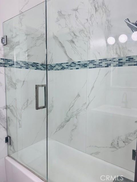 bathroom featuring enclosed tub / shower combo