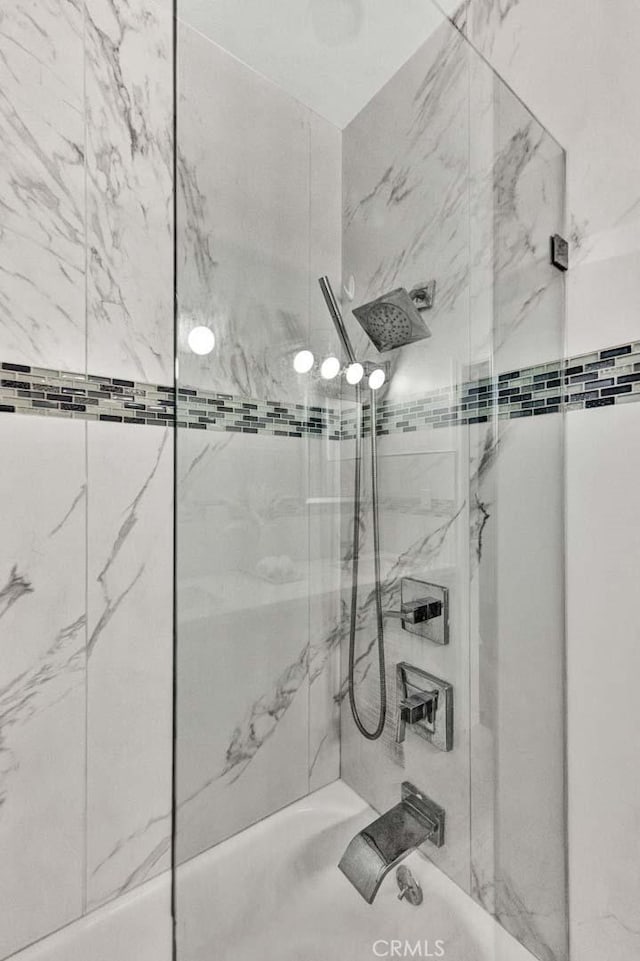 bathroom with bathing tub / shower combination