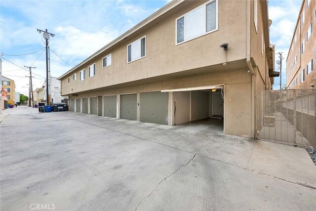 2049 E 3rd St Unit 3, Long Beach, CA 90814 - rear view of house featuring stucco siding and fence