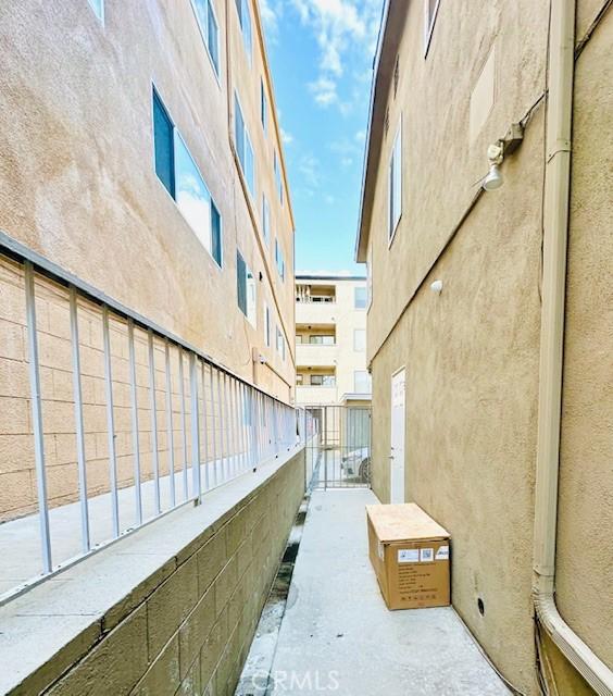 exterior space with stucco siding and a balcony